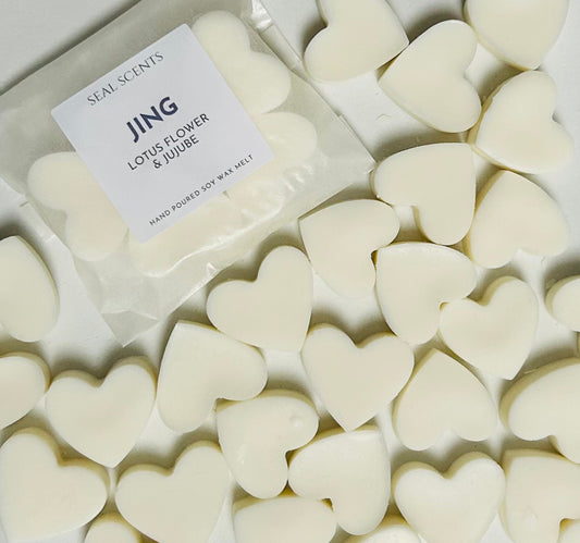 Heart-shaped wax melts with a 'JING' label on a white background